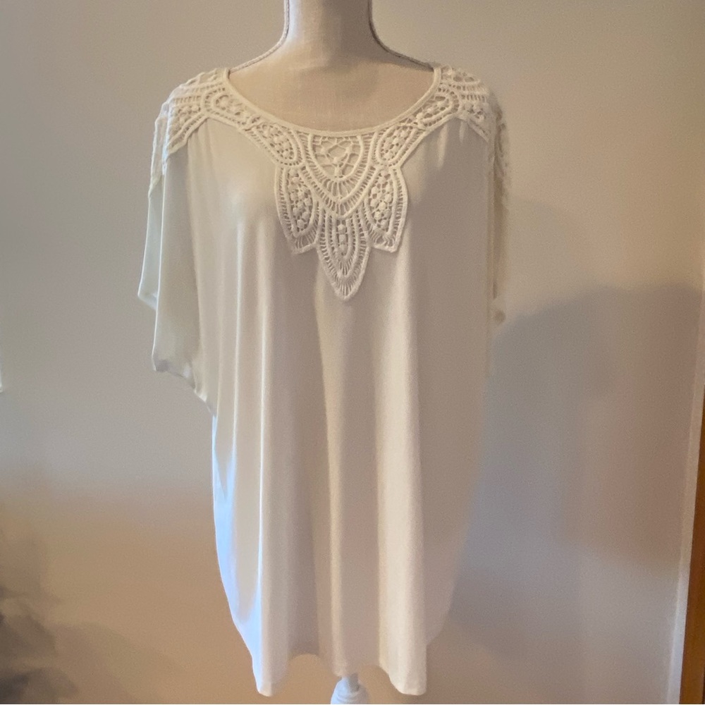 Embroidered short sleeve blouse.  23” from the neckline to the bottom